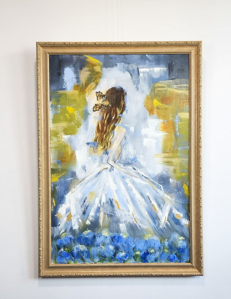 Framed painting of a woman in a white dress with blue flowers on a white wall