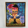 Framed artwork of a stylized face with floral elements and an owl on a white wall.